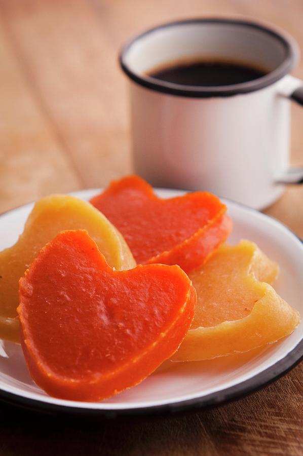 Heart-shaped Candies Of Pumpkin orange And Sweet Potato yellow With Cup Of Coffee On The Background Photograph by Flvio Coelho