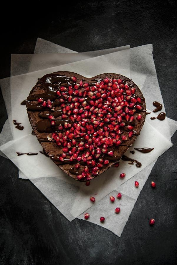 Heart-shaped Chocolate Cake With Chocolate Glaze And Pomegranate Seeds Photograph by Magdalena Hendey