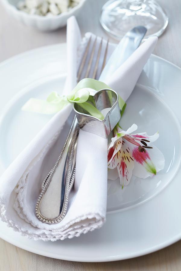 Heart-shaped Pastry Cutter As Napkin Ornament And Lily On Plate Photograph by Franziska Taube