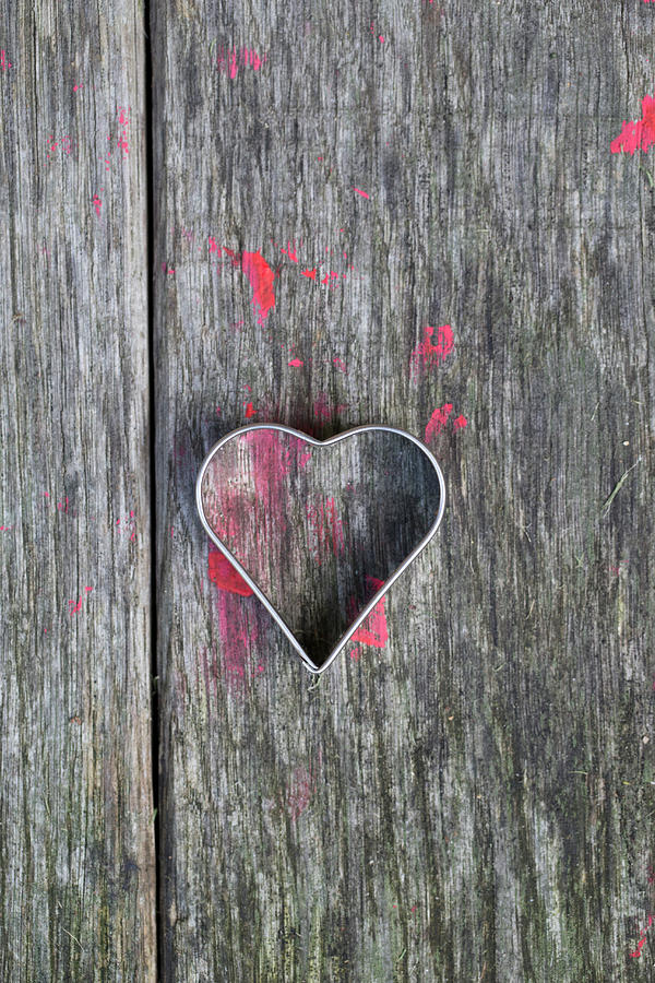 Heart-shaped Pastry Cutter On Wooden Surface Splattered With Red Paint Photograph by Iris Wolf