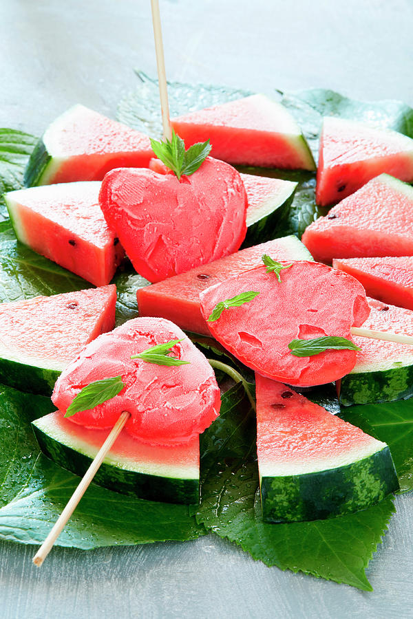 Heart-shaped Watermelon Popsicles On Slices Of Watermelon Photograph by ...