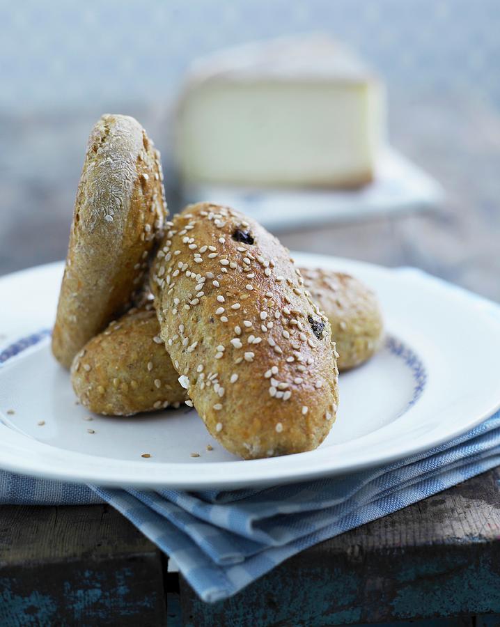 Hearty Bread Rolls With Raisins And Sesame Seeds Photograph by Mikkel Adsbl
