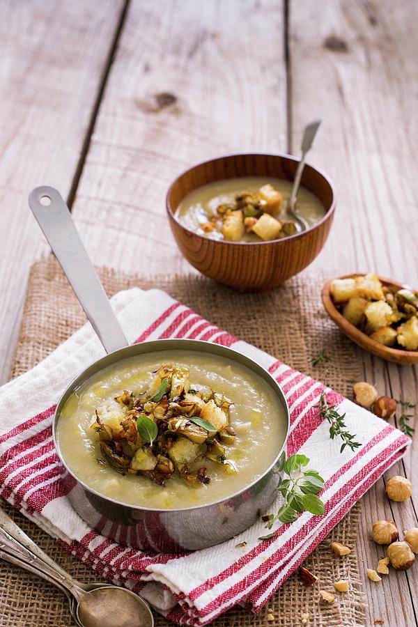 Hearty Winter Soup With Roasted Artichokes, Hazelnuts And Croutons Photograph by Maricruz Avalos Flores