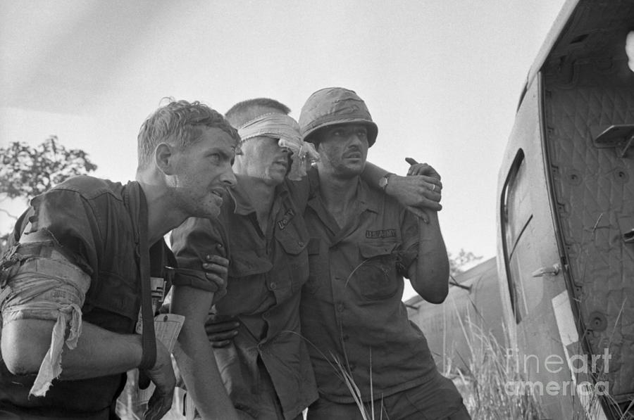 Helping A Wounded Soldier Photograph by Bettmann