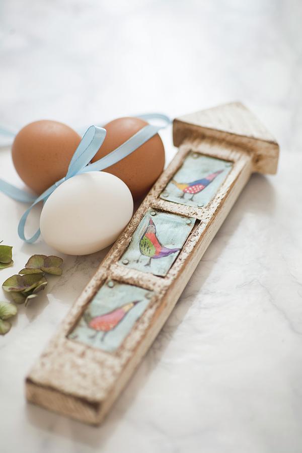 Hens Eggs With A Ribbon And A Wooden Signpost On A Marble Surface Photograph by Alicja Koll