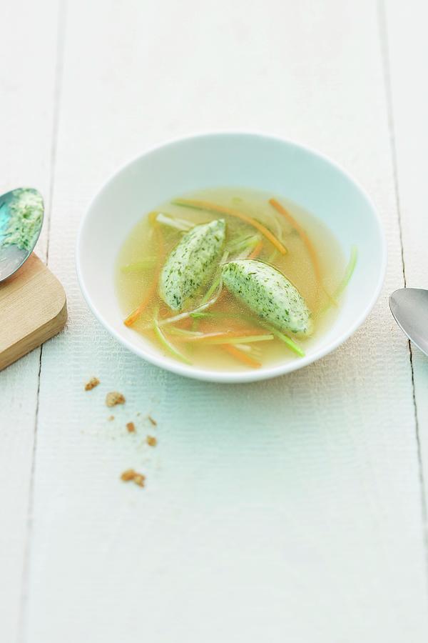 Herb And Quark Dumplings In Vegetable Stock Photograph by Michael Wissing