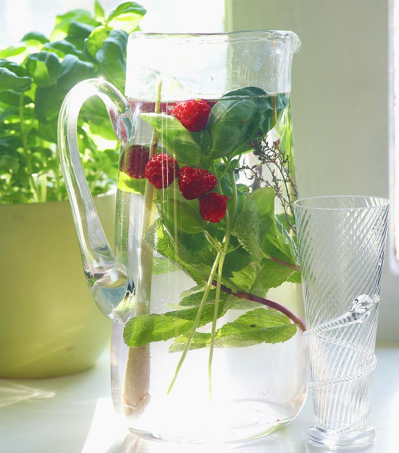 Herb-infused Water With Raspberries Photograph by Nele Braas