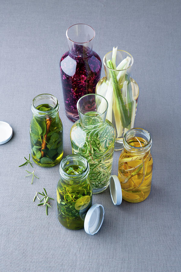 Herb Oils And Vinegars With Thyme, Rosemary, Basil, Sage And Coriander Photograph by Michael Wissing