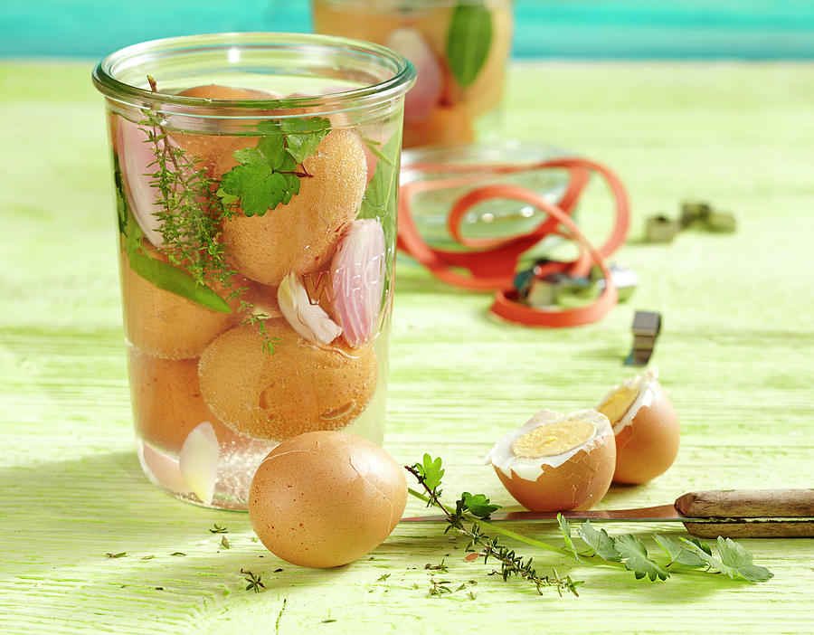 Herb Pickled Eggs In A Jar With Bay Leaves, Onions, Garlic, Thyme And Burnet Saxifrage Photograph by Teubner Foodfoto