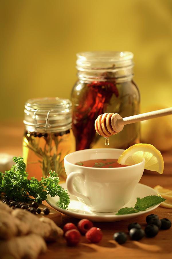 Herb Tea Being Sweetened With Honey Photograph by Perry Jackson