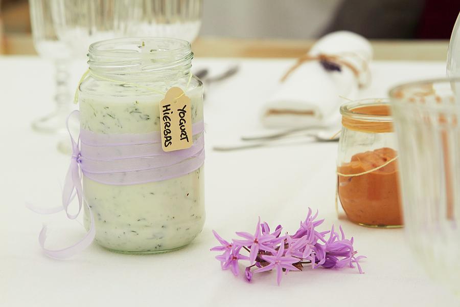 Herb Yoghurt In A Glass With A Purple Ribbon On A Table Photograph by Miriam Rapado