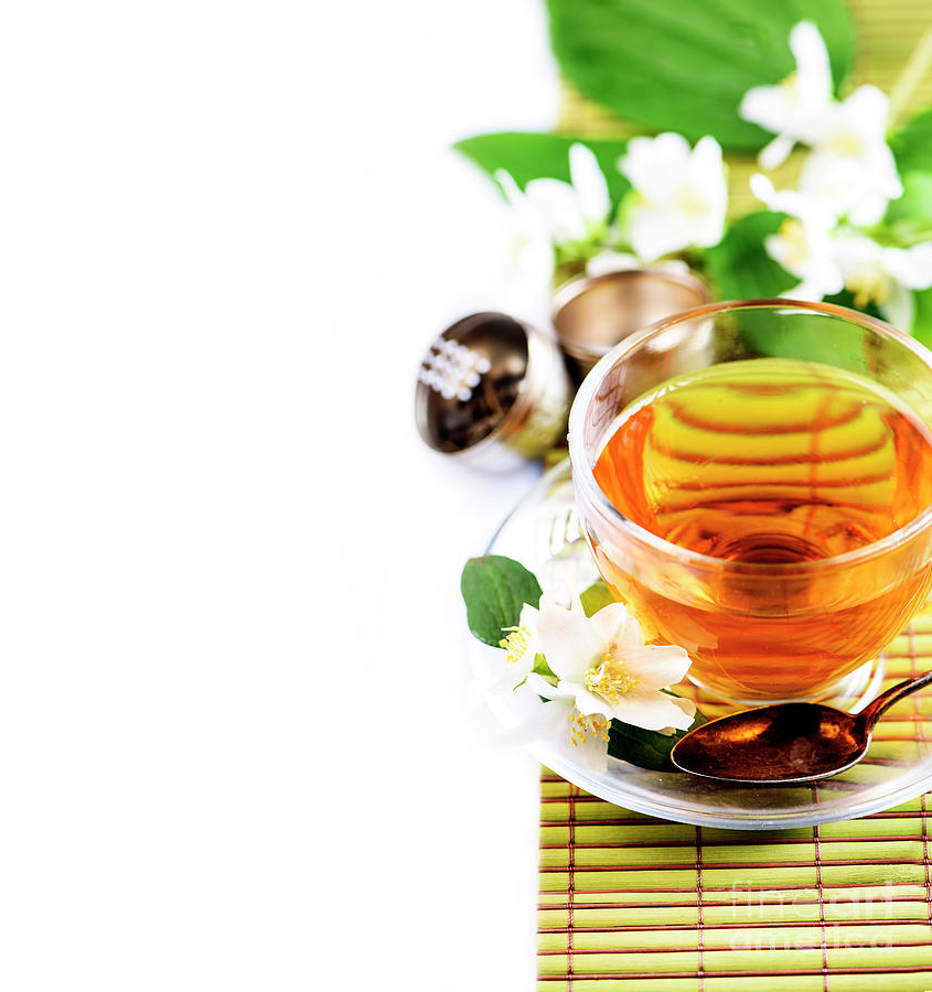 Herbal green tea with jasmine flower in transparent teacup borde Photograph by Jelena Jovanovic