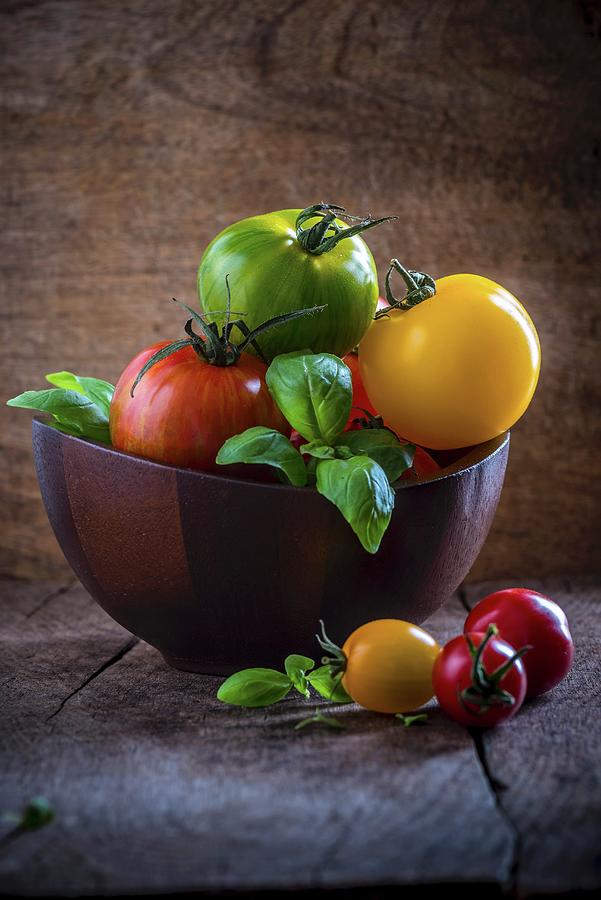 Heritage Tomatoes With Basil In A Wooden Bowl Photograph by Nitin Kapoor