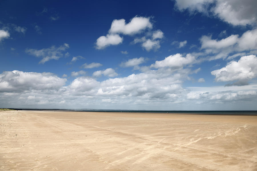 High wind on wide long St Andrews West Sands beach with blue sky Photograph by Reimar Gaertner