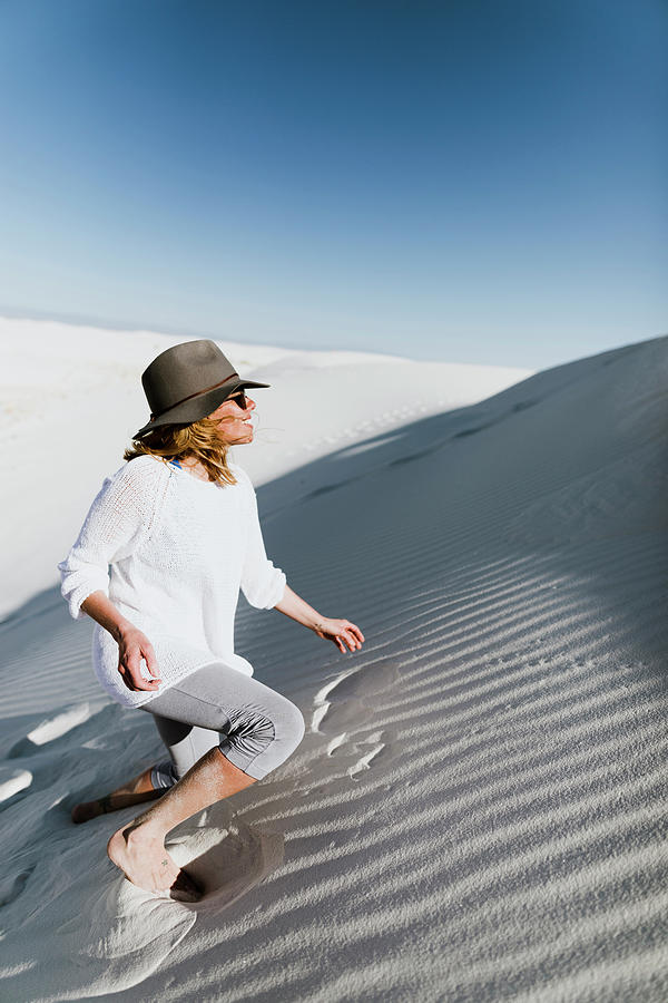 White Sands National Monument Photograph - Hiker Climbing On Desert At White Sands National Monument During Sunny Day by Cavan Images