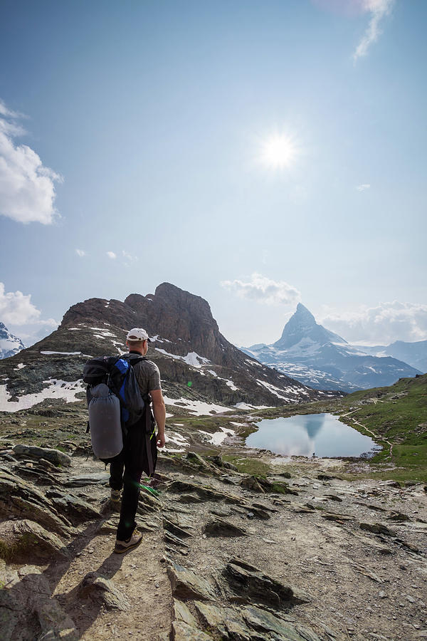 Hiker In The Swiss Alps Near Photograph by Matteo Colombo