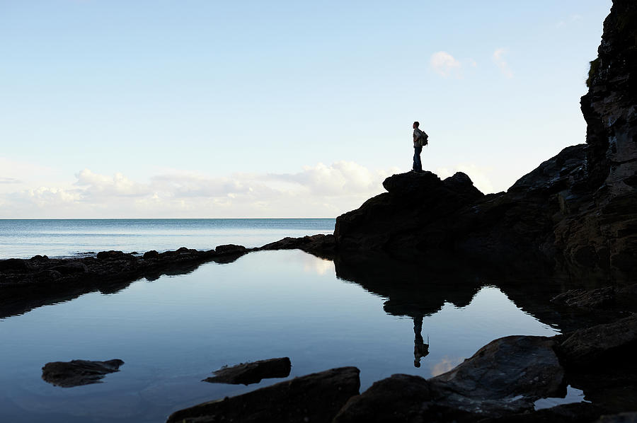 Hiker Looking Out To Sea From Coastal Photograph by Dougal Waters