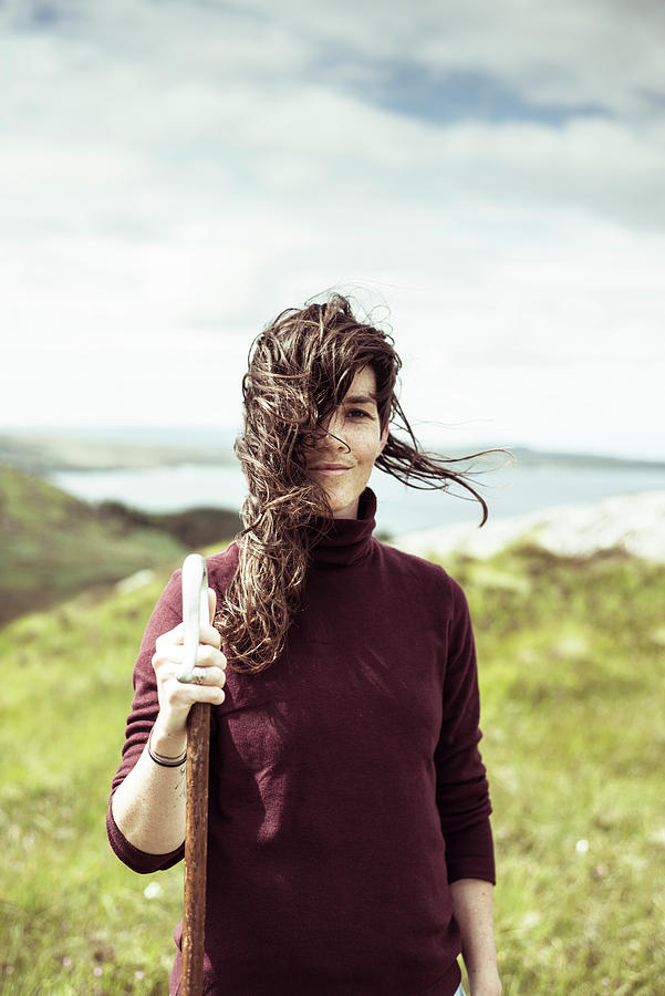 Hiking Girl Smiles With Wind Blowing Hair On Wild Coastline Photograph By Cavan Images