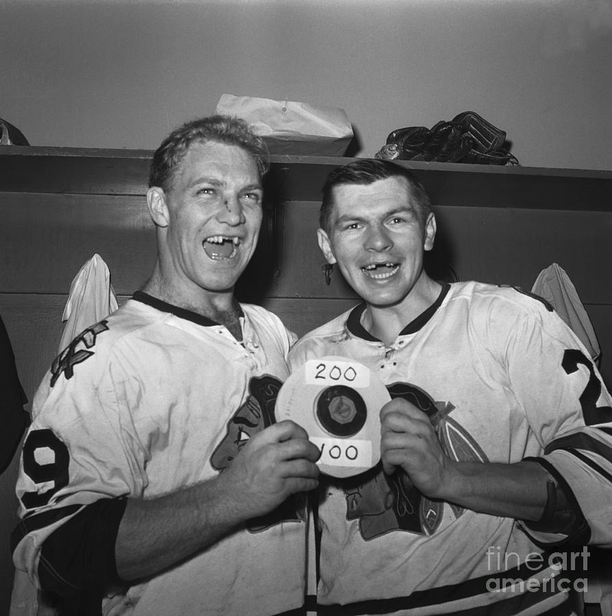 Hockey Players With Puck In Locker Room Photograph by Bettmann