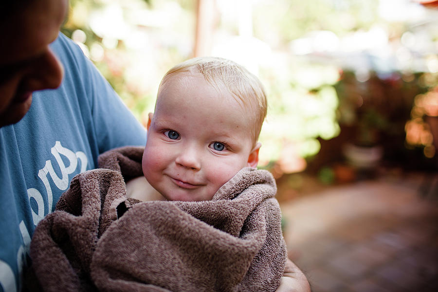 San Diego Photograph - Holding Holding Nephew Wrapped In Towel In San Diego by Cavan Images