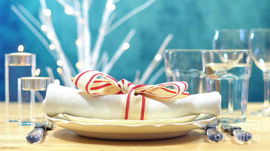 Holiday table place setting with focus on napkin Photograph by Milleflore Images