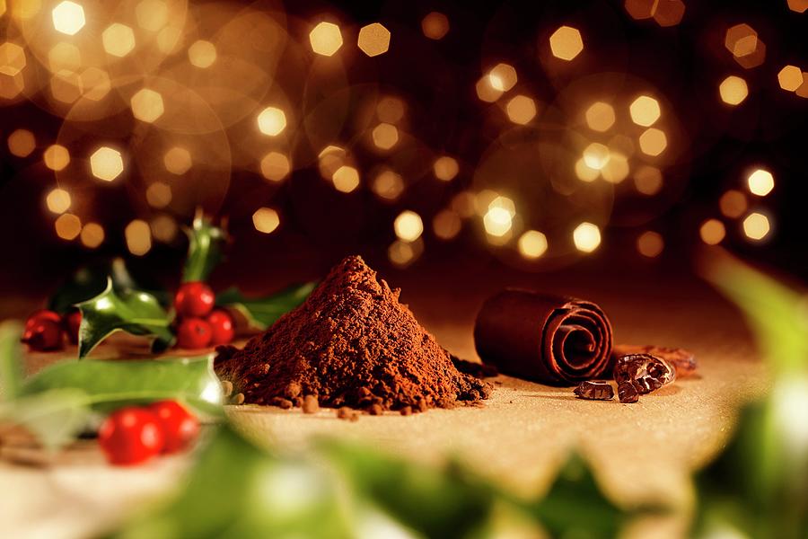 Holly On A Wooden Table With A Pile Of Cocoa Powder, Cocoa Beans And Chocolate Rolls christmas Photograph by Luzzitelli Danieli & Associati S.a.s.