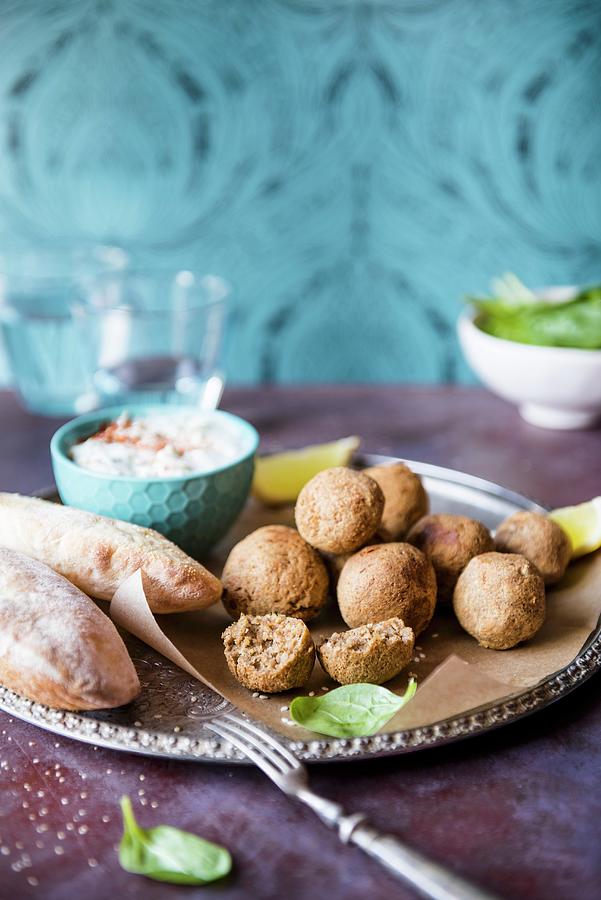 Home-made Falafels With Tzatziki cucumber & Yoghurt Dip, Spinach And Pitta Bread Photograph by Magdalena Hendey