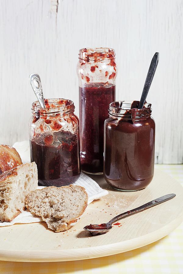 Home-made Jam And Chocolate Spread, Served With Bread Photograph by Grudzinska-sarna, Anna
