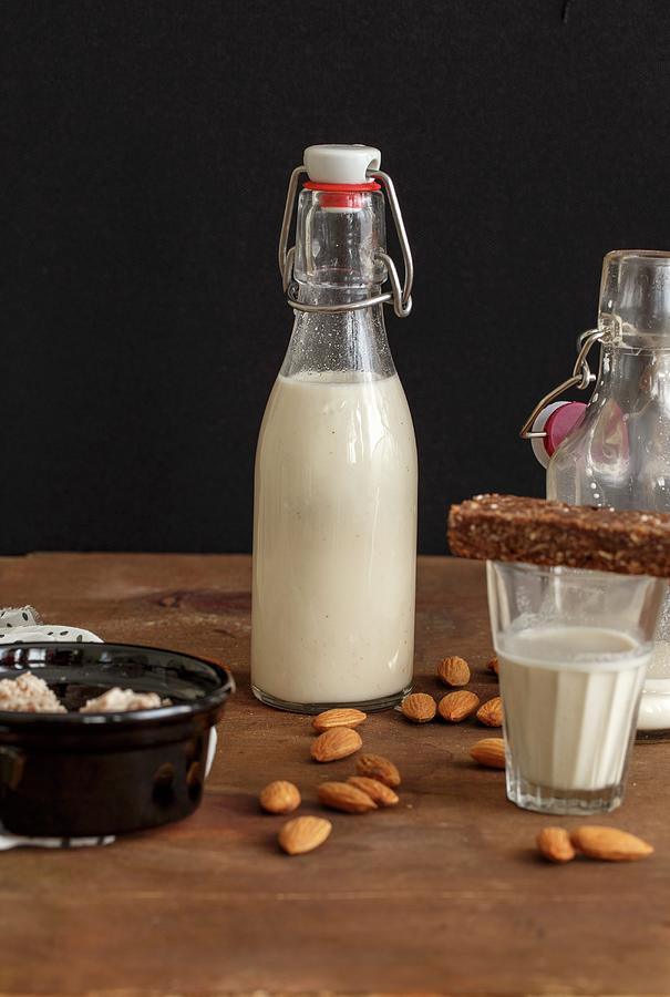 Homemade Almond Milk In A Flip-top Bottle And A Glass Photograph by Sandhya Hariharan