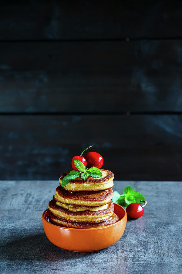 Homemade American Pancakes Topped With Berries, Honey And Mint Leaves Photograph by Yuliya Gontar