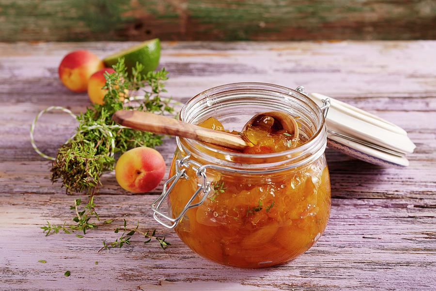 Homemade Apricot Jam With Fresh Thyme In A Mason Jar Photograph by Teubner Foodfoto