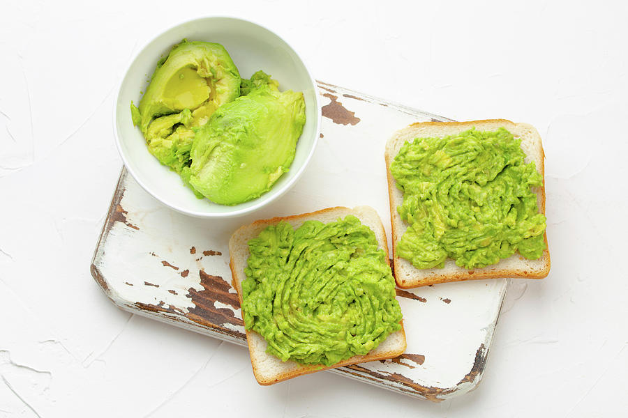 Homemade Avocado Toasts And Smashed Fresh Ripe Avocados In Bowl