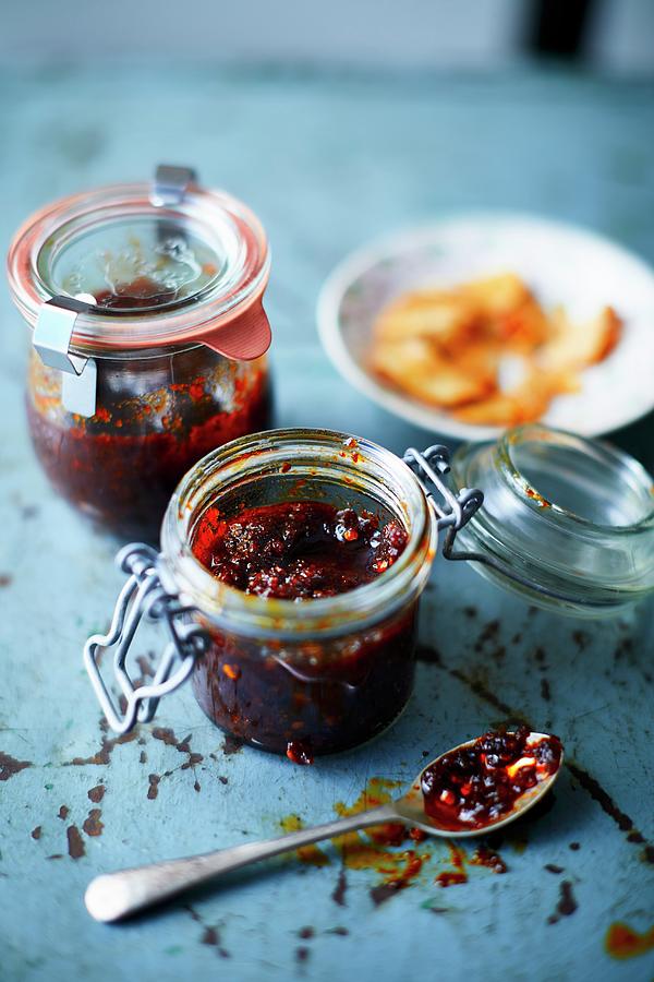 Homemade Chilli Paste In Preserving Jars Photograph by Tom Regester