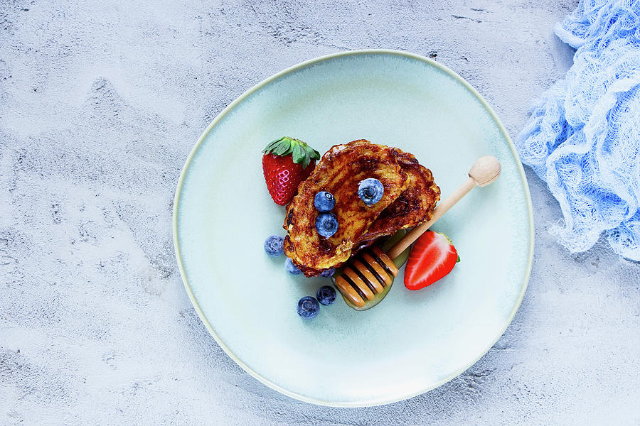 Homemade Cinnamon French Toasts With Blueberries, Strawberries And Honey In Ceramic Plate For Tasty Breakfast On Concrete Textured Background Photograph by Yuliya Gontar