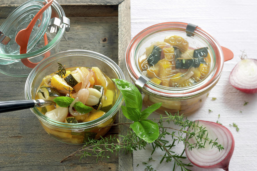 Homemade Courgette Antipasto With Garlic, Fresh Herbs And Vinegar In Jars Photograph by Teubner Foodfoto