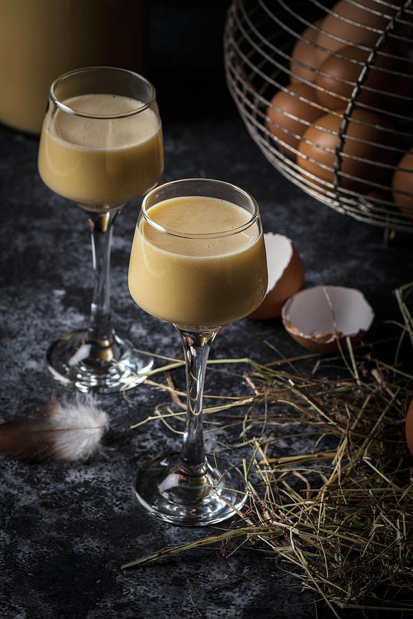 Homemade Egg Liqueur Next To An Old Wire Basket With Fresh Eggs On Straw Photograph by Christian Kutschka