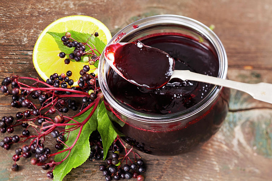 Homemade Elderberry And Orange Jelly In A Glass With A Spoon Photograph by Teubner Foodfoto