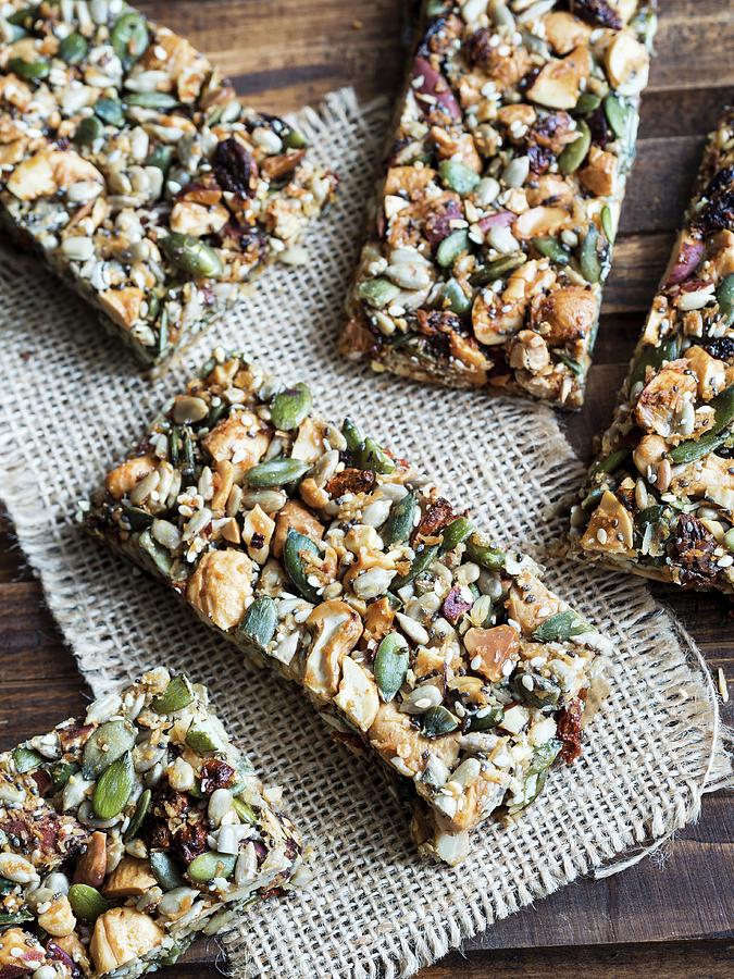 Homemade Gluten-free Paleo Nut Bars On A Wooden Table Photograph by Magdalena Paluchowska
