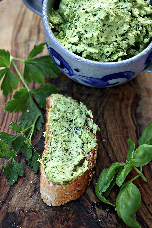 Homemade Herb Butter On A Slice Of Baguette On An Olive Wood Board Photograph by Alexandra Panella