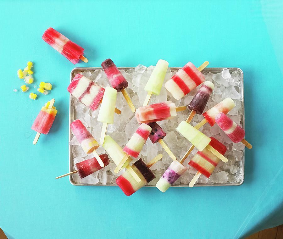 Homemade Ice Lollies On Tray Of Ice Cubes Photograph by Vincent Noguchi Photography