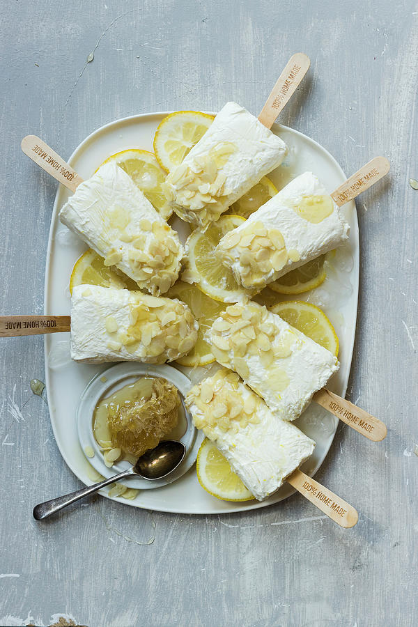 Homemade Icecream Popstickles With Greek Yogurt, Lemons Juice, With Honey And Almond Flakes Photograph by Zuzanna Ploch