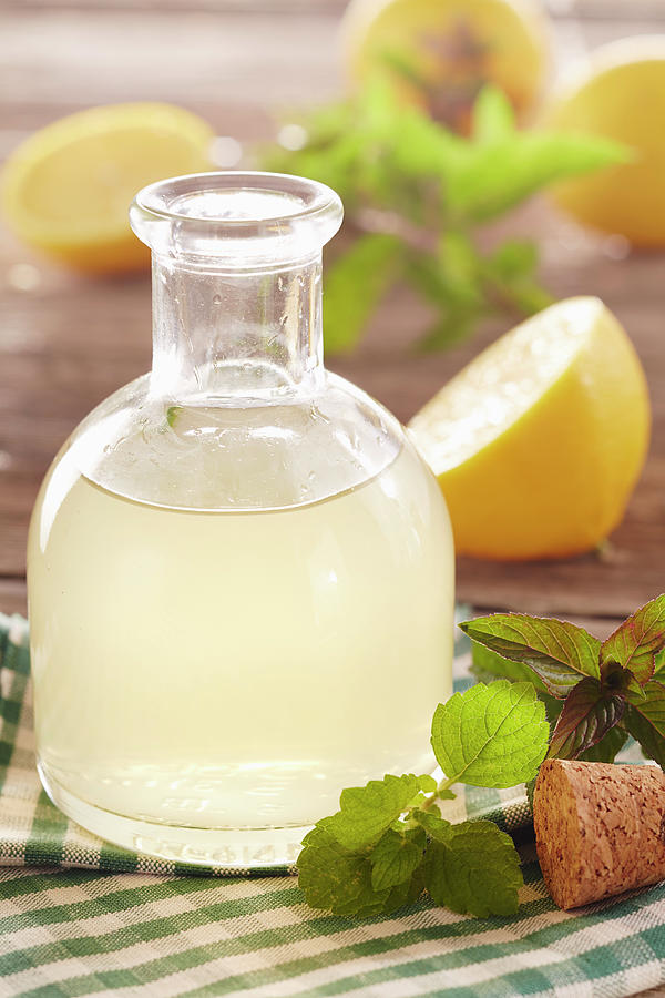 Homemade Lemon Syrup With Mint And Lemon Balm In A Vial Photograph by Teubner Foodfoto