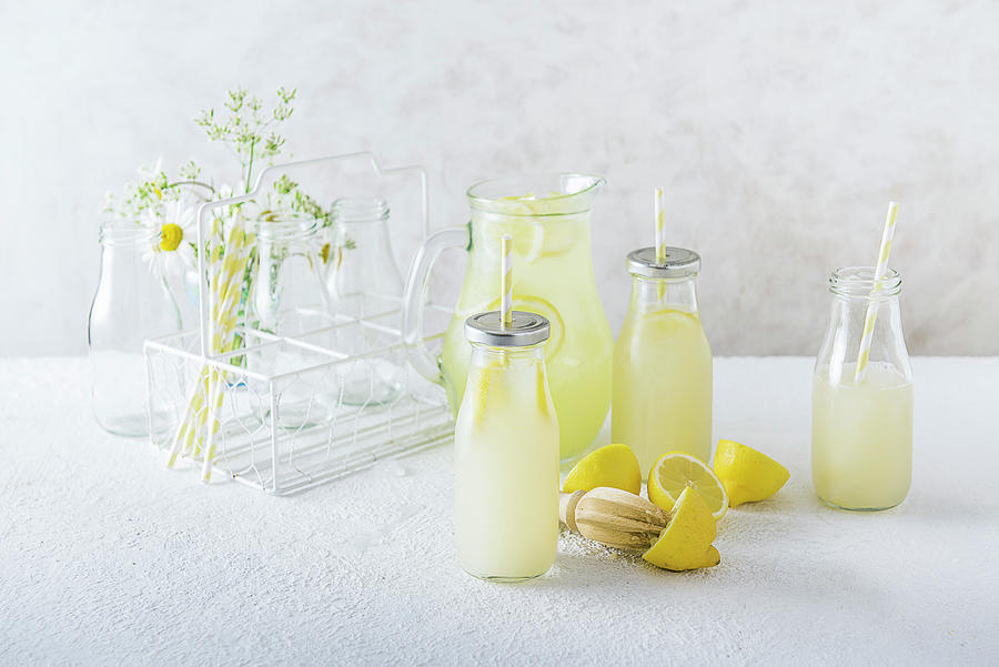 Homemade Lemonade In A Jug And Serving Bottles Photograph by Magdalena Hendey