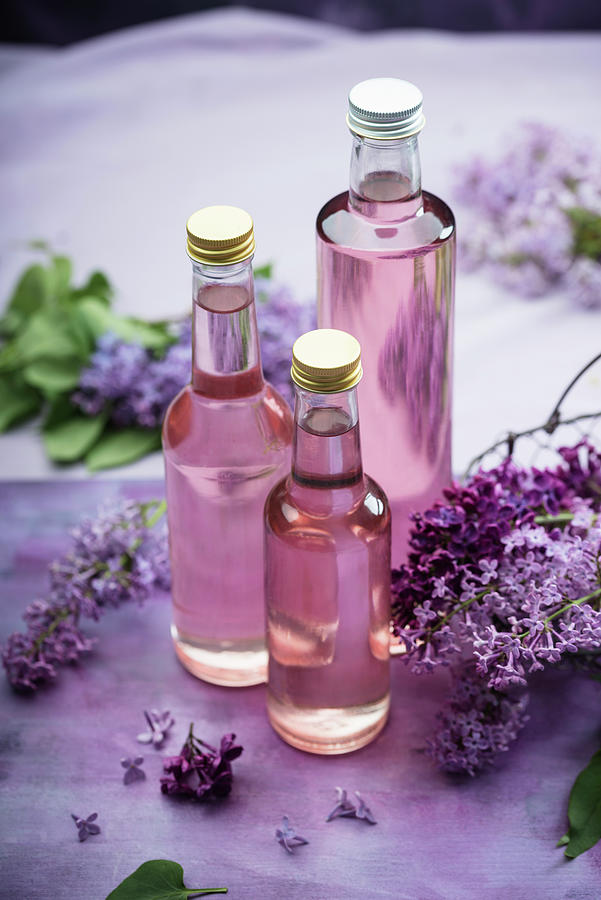 Homemade Lilac Syrup In Bottles Photograph by Kati Neudert