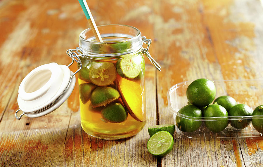 Homemade Limequat Vinegar With Fresh Limes In A Glass Photograph by Teubner Foodfoto