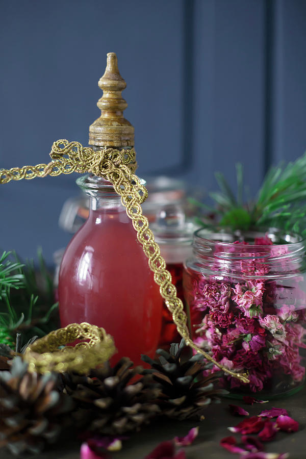 Christmas Photograph - Homemade Liqueur And Dried Flowers In Jars As Christmas Presents by Alicja Koll