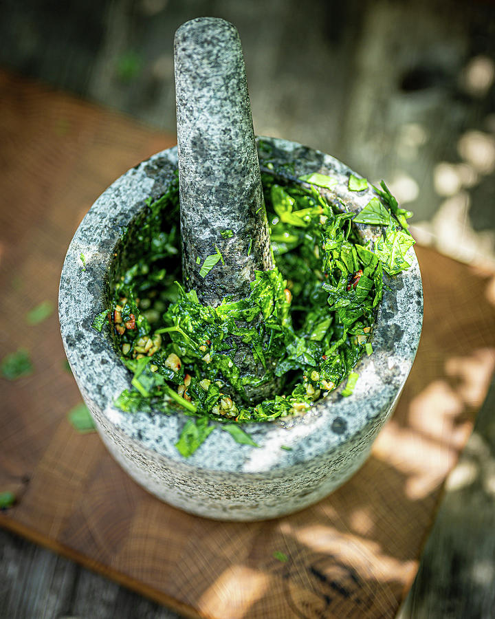 Homemade Lovage Pesto In A Mortar Photograph by Sebastian Schollmeyer