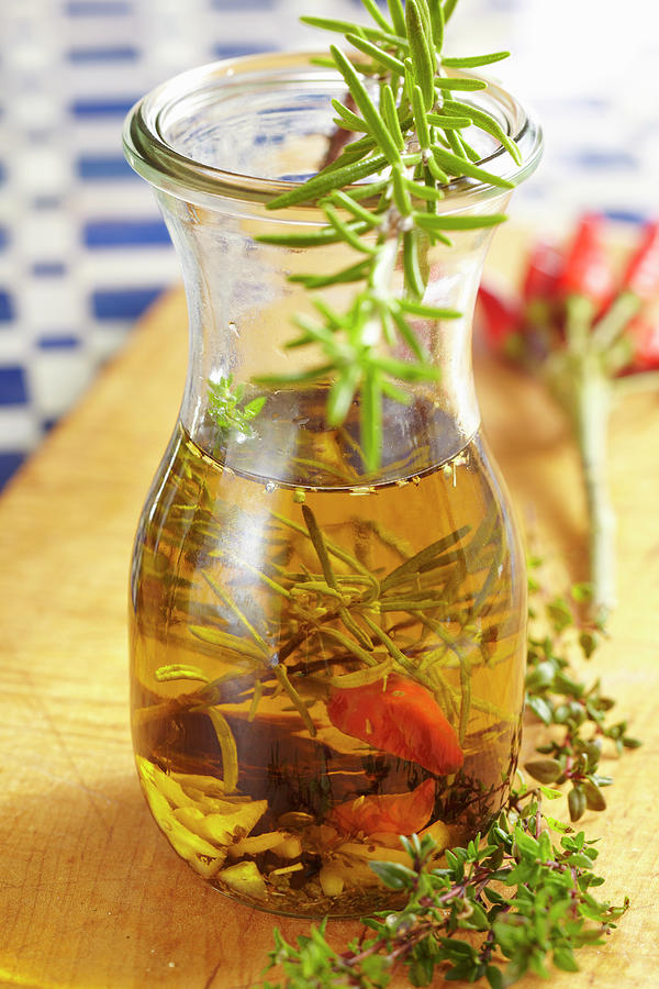 Homemade Mediterranean Olive Oil With Herbs And Chilli Photograph by Teubner Foodfoto