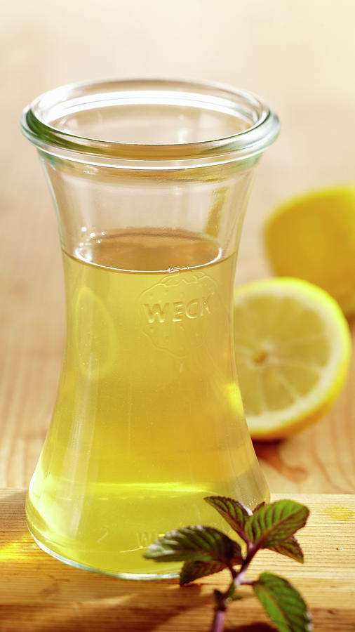 Homemade Peppermint And Lemon Vinegar In A Glass Bottle Photograph by Teubner Foodfoto