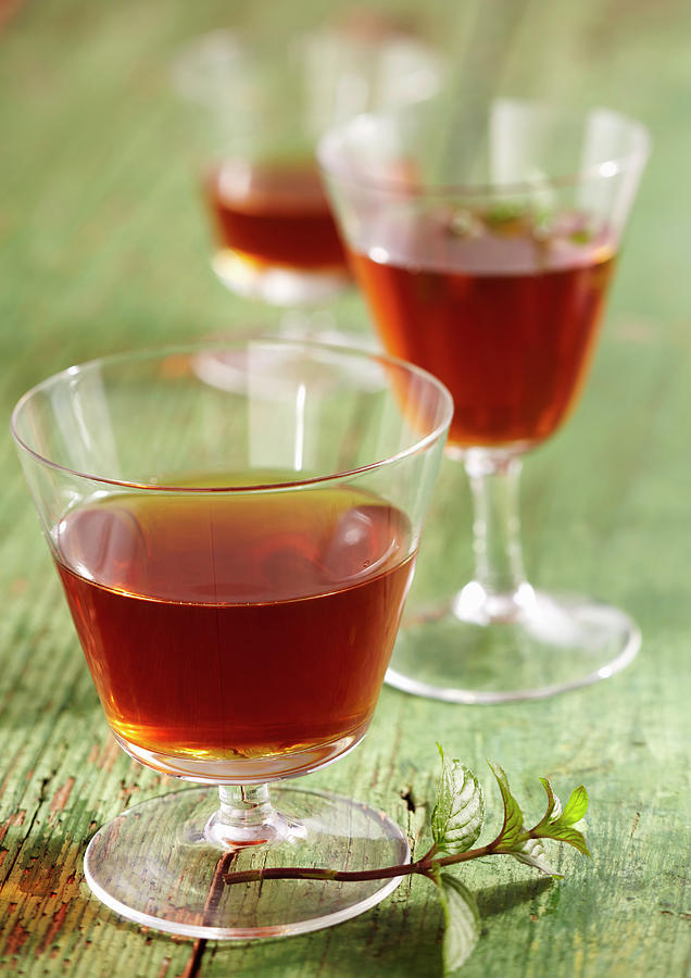 Homemade Peppermint Liqueur With Wine Spirit, Mint, Nutmeg, Cloves, Orange And Sugar Photograph by Teubner Foodfoto